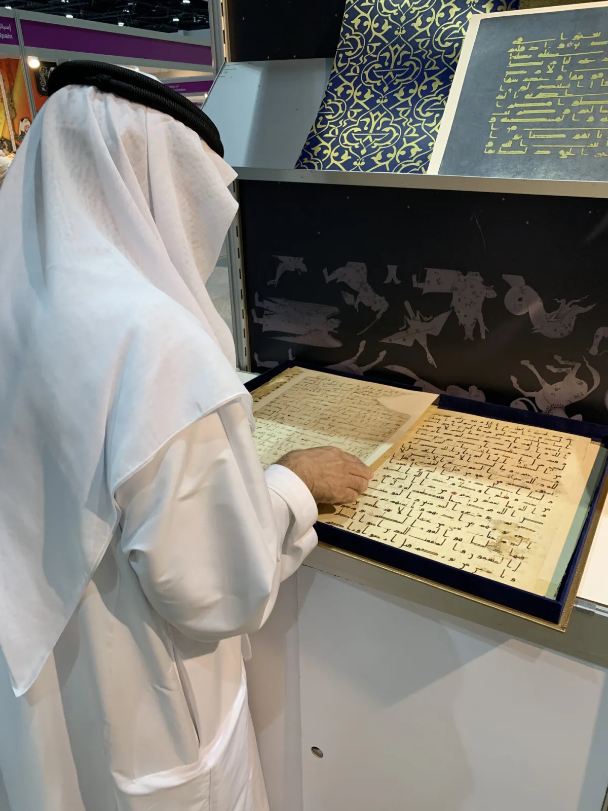 A visitor attentively admiring one of our works during the ADIBF.