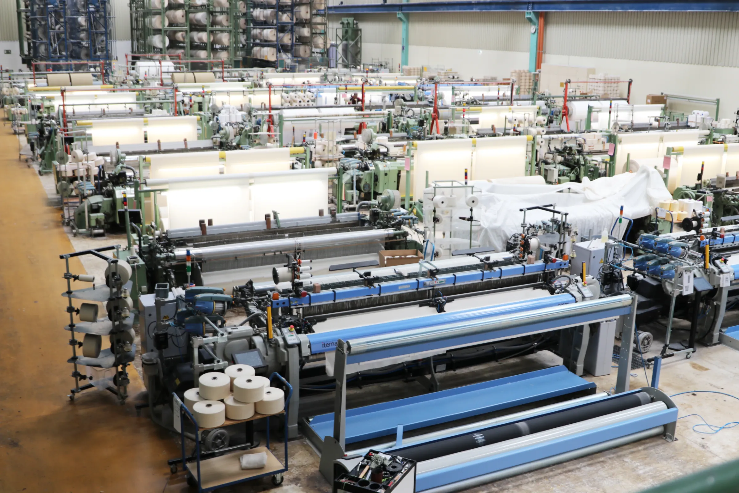 Weaving Department: The "heart" of our company. Our weaving machines are combining warp and weft to create different embroidery fabrics and canvases.