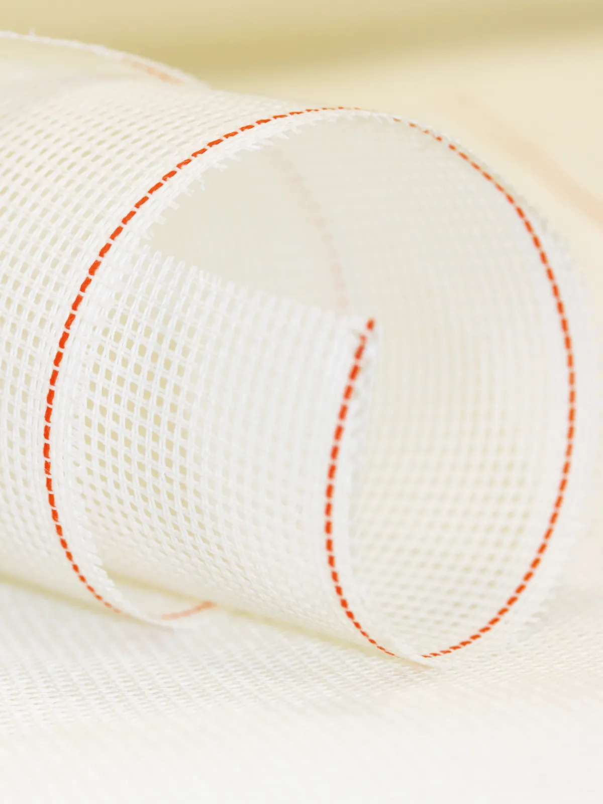 Our trademark is the "Orange Line" - an orange-coloured thread in the selvedge of all  ZWEIGART® fabrics. This is our sign for best quality and state-of-the-art fabrics that are absolutely precise in the weaving. That’s ZWEIGART® "Made in Germany.