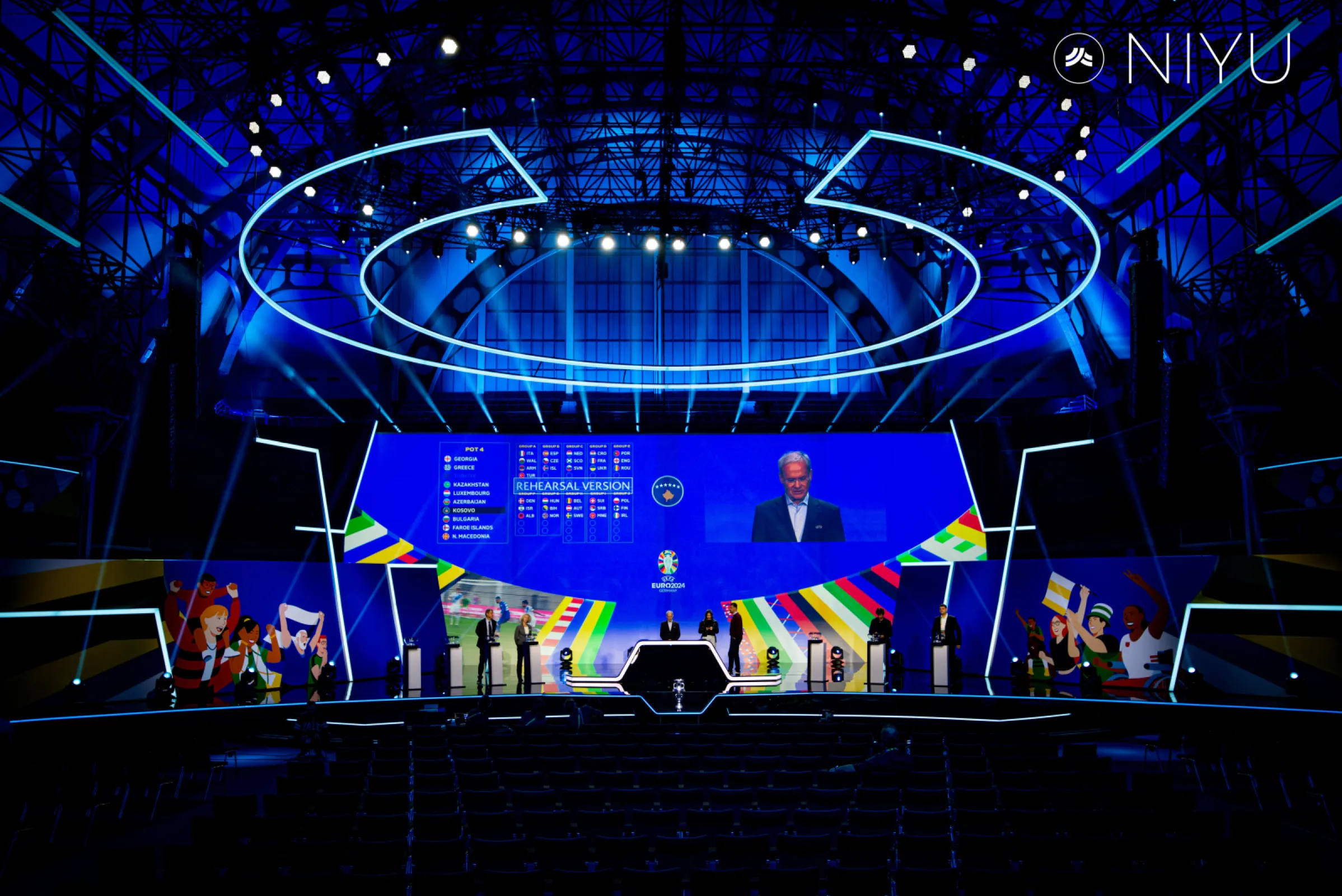 UEFA EURO 2024 Qualifying Draw – Frankfurt, Germany. Directly awarded by UEFA, NIYU delivered full-scope technical services for the prestigious draw — including rigging, lighting, sound, video, and stage management. A custom roof-mounted audio absorber was engineered to ensure crystal-clear sound throughout the venue.  No audio or video problems with NIYU.