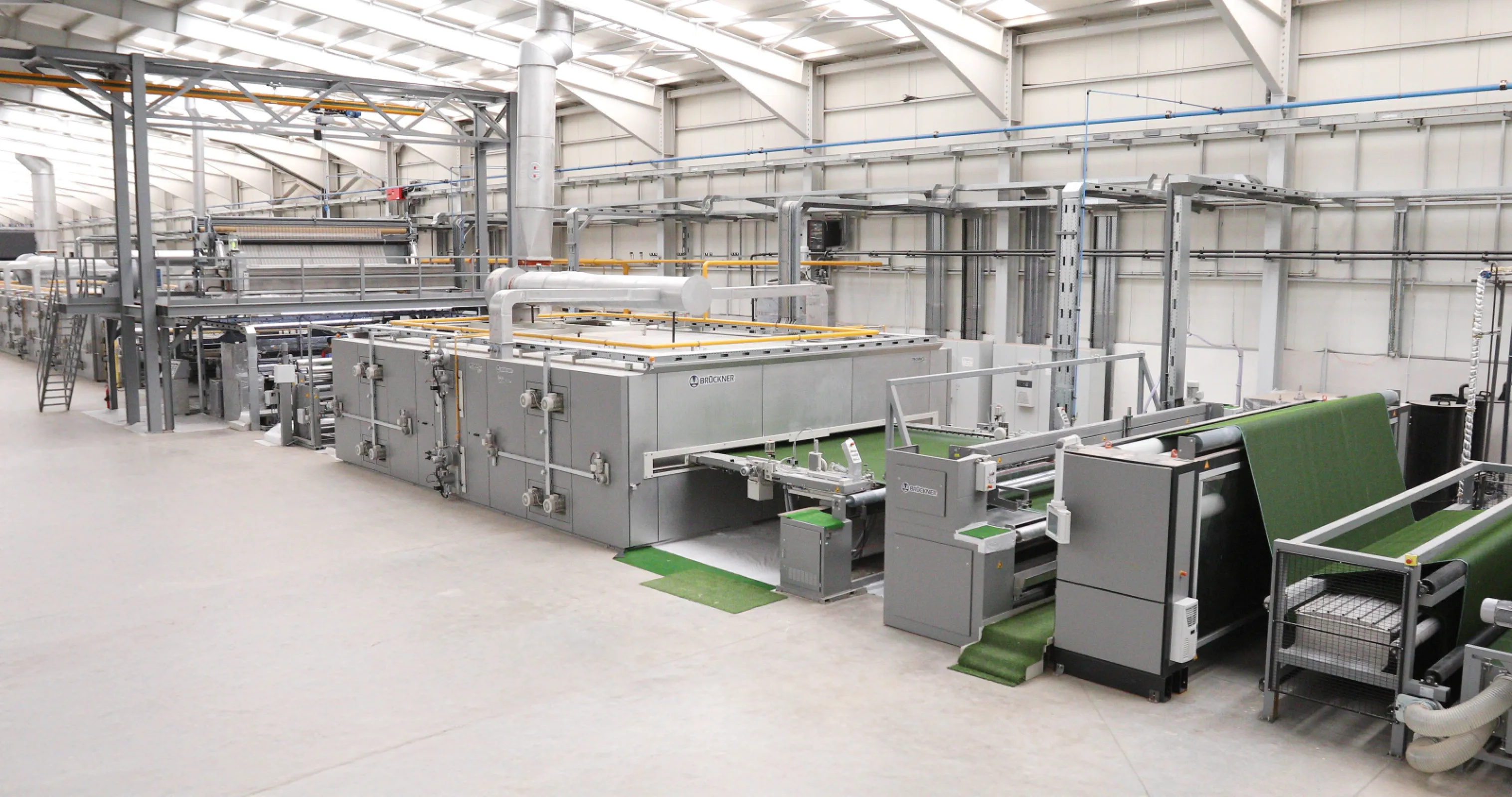 Bruckner back-coating and finishing line for artificial turf