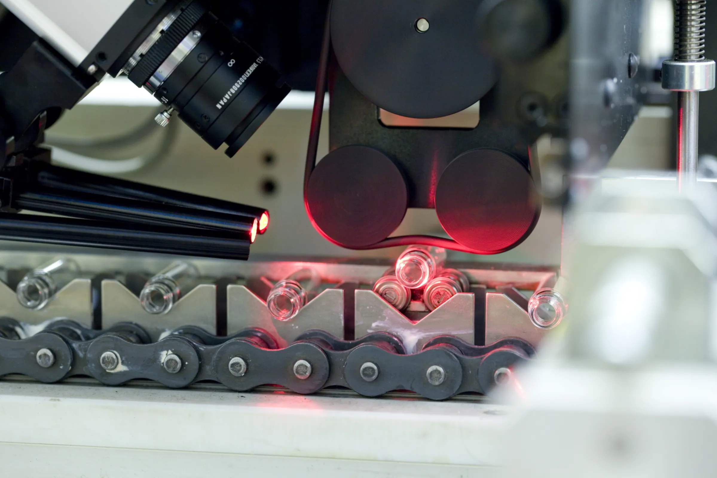 Intelligent multi-camera system for quality control of vaccine bottles.