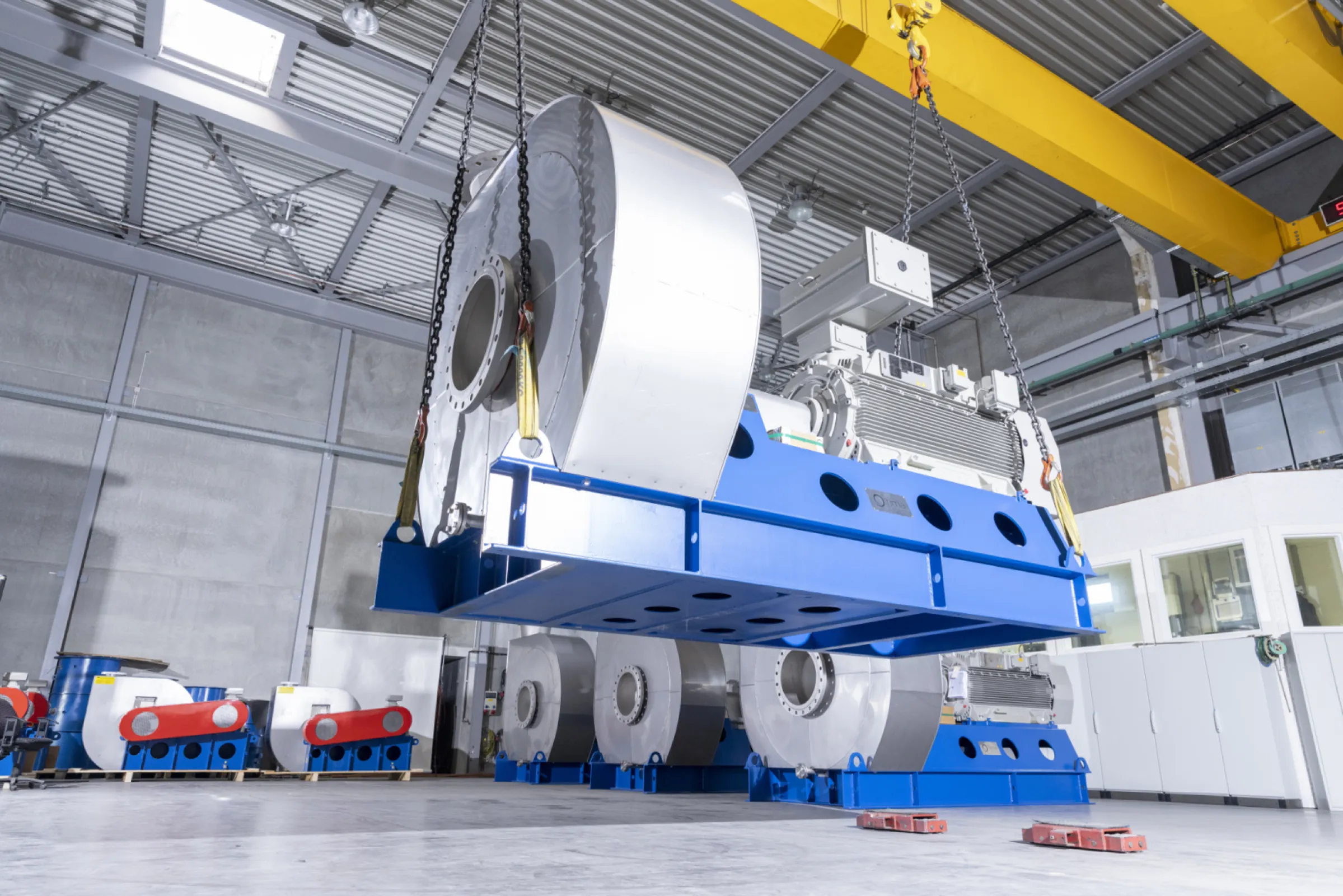 For loading one FIMA blower hangs on the crane in the test bay.