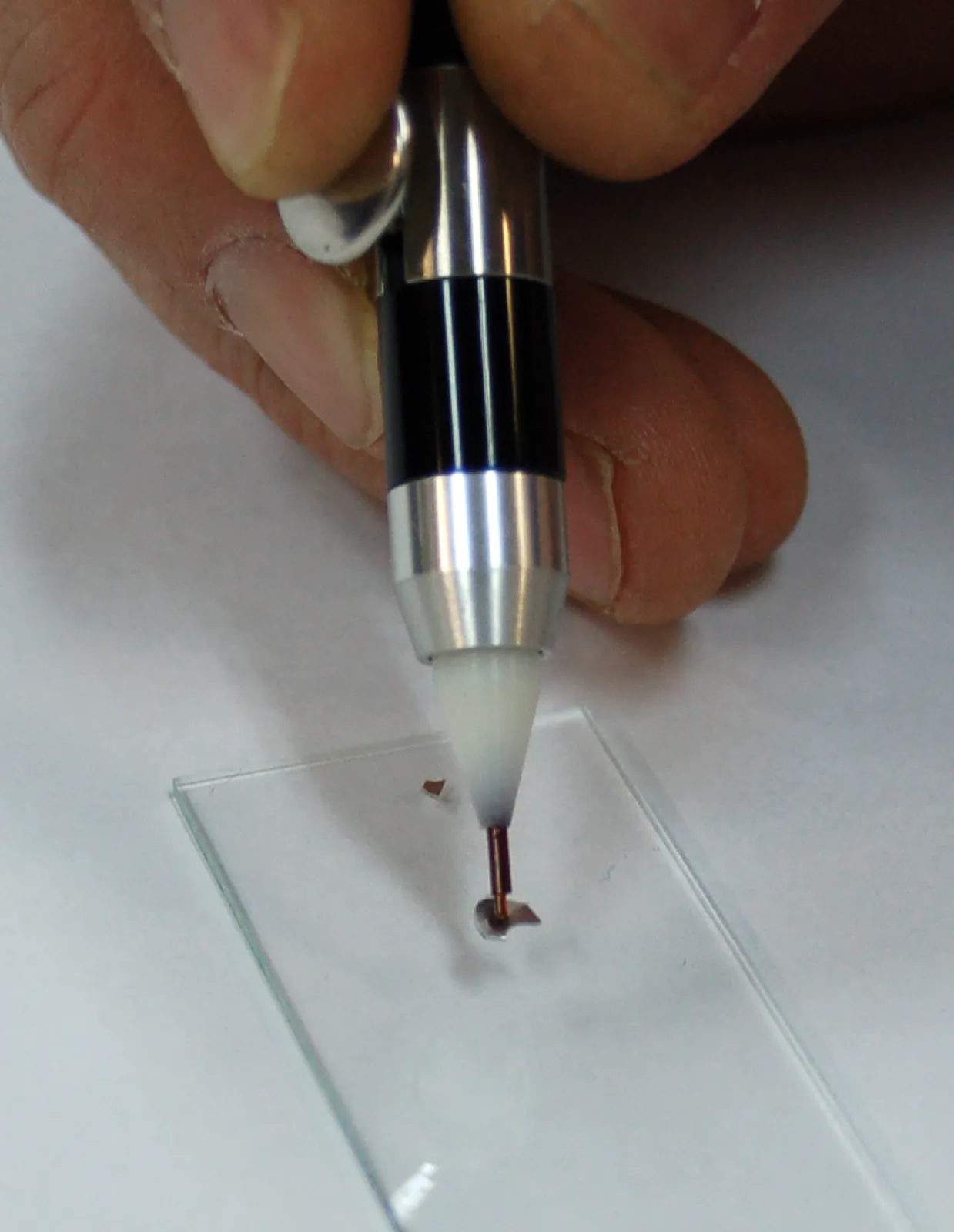 Close-up of the Micro TouchPick Pen picking up a micro particle
