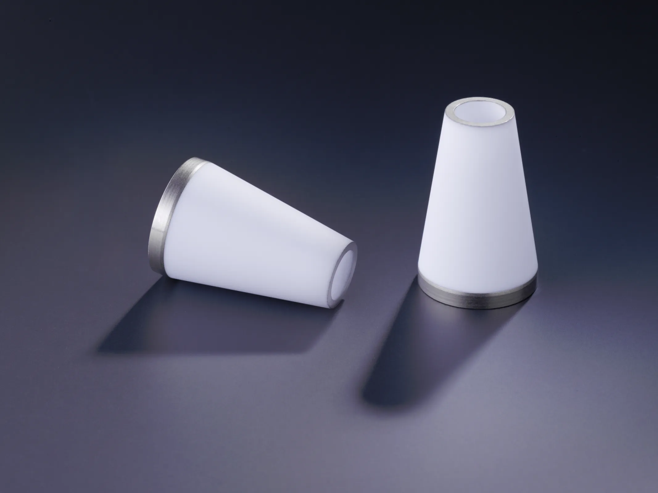 Alumina-based high-performance ceramic insulators in various shapes and sizes, designed for use in high-voltage and high-temperature applications. The image shows precise machining and metallization features typical for components produced by QSIL Ceramics.