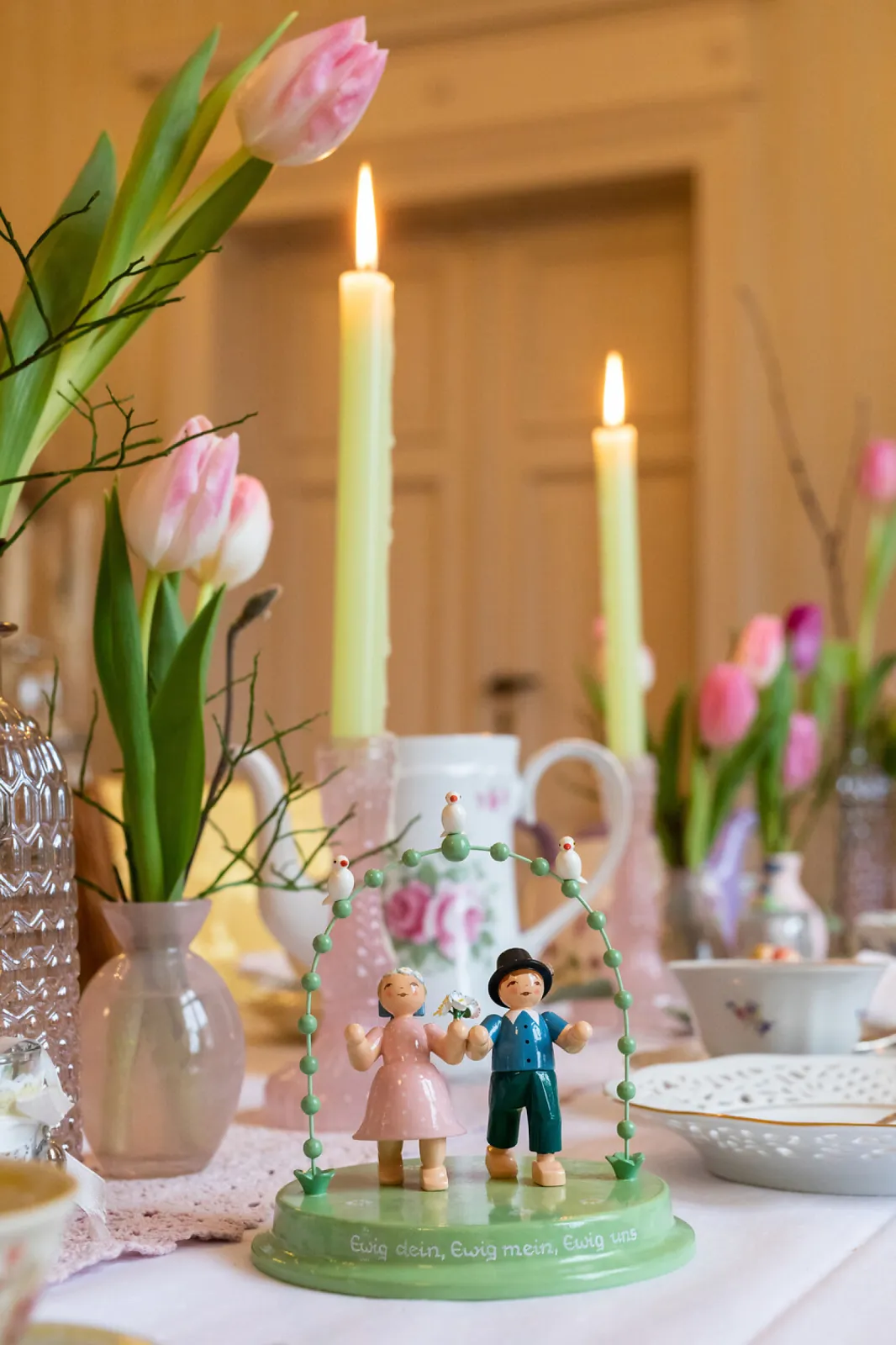 No wedding table should be without a loving couple under an arch.