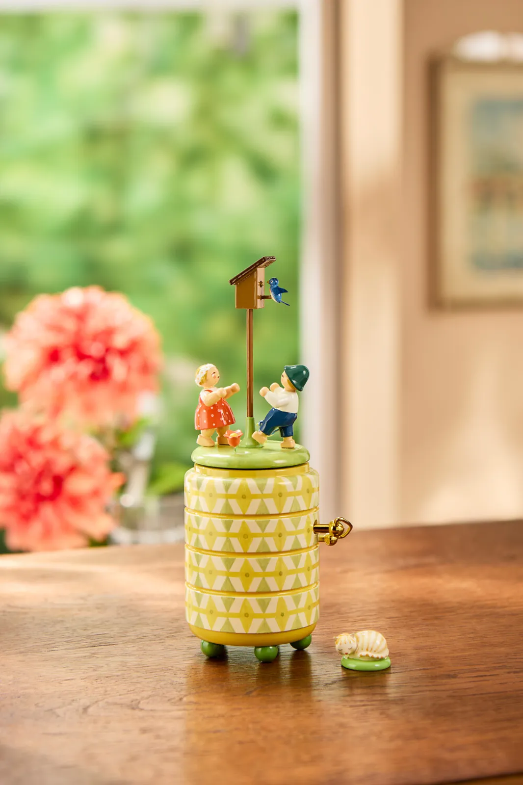 The two children dance joyfully around the star box to the melody of the music box.