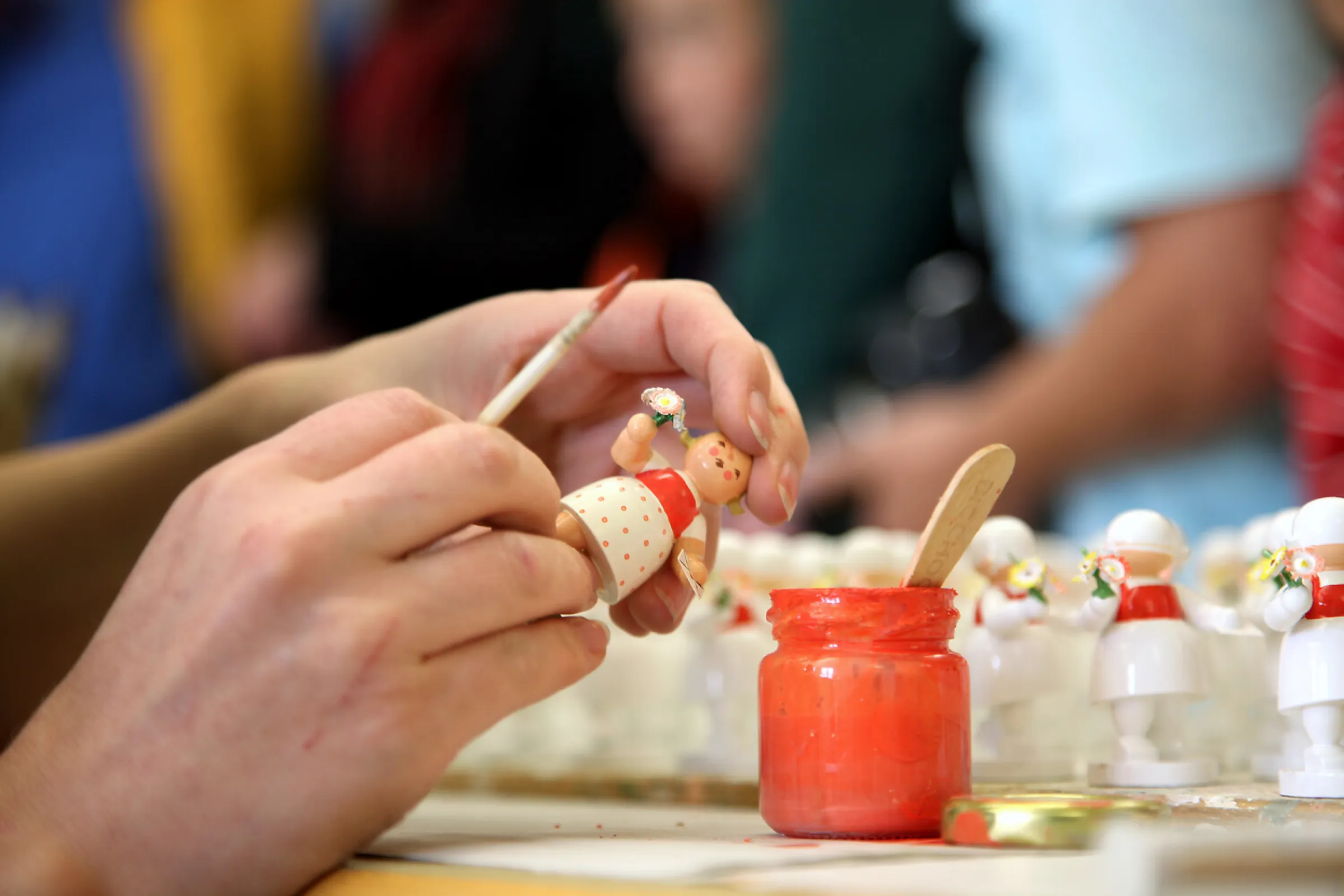 Experienced hands painstakingly apply fine brushstrokes to each figurine.
