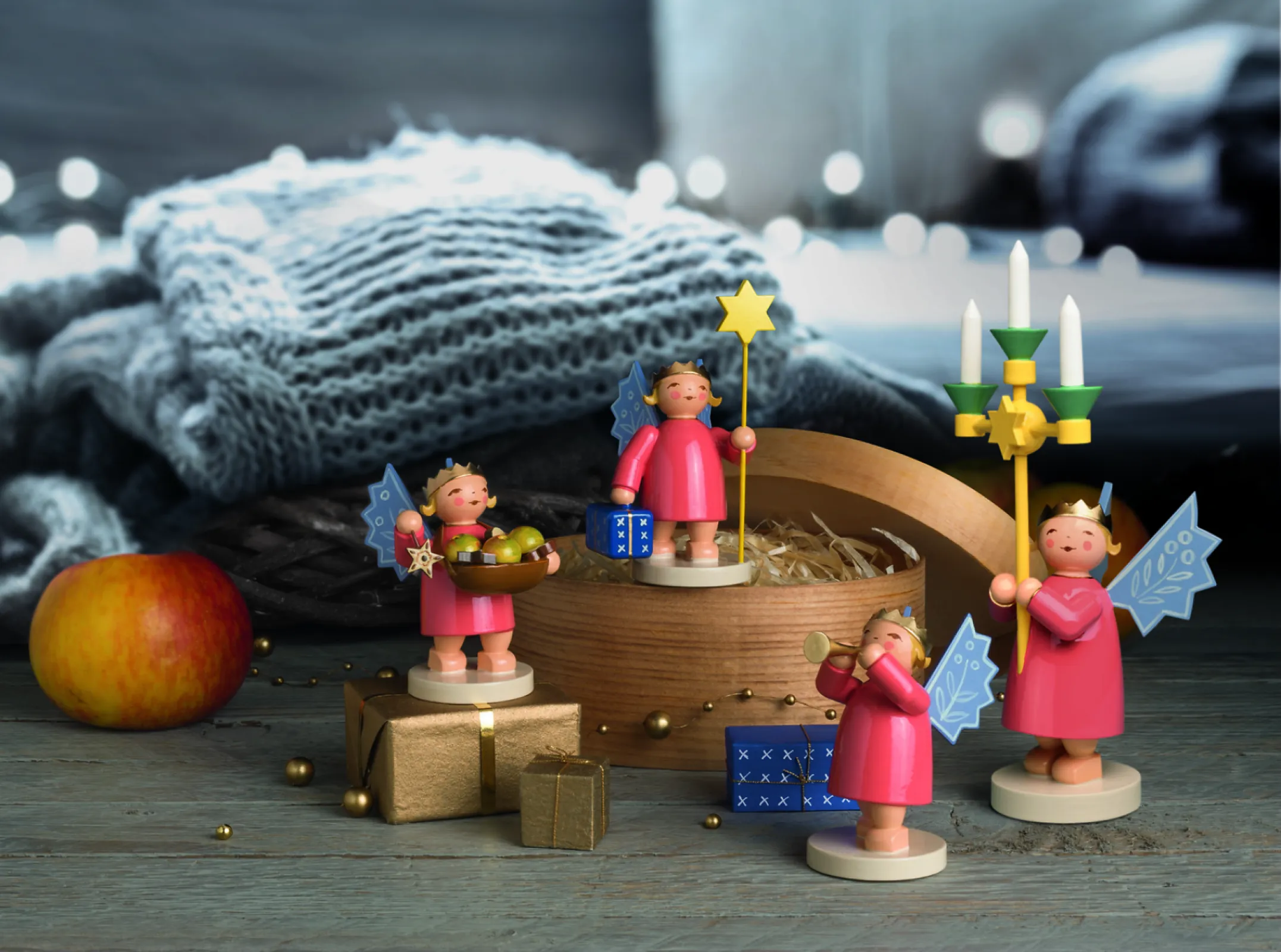 They wear their golden crowns proudly on their heads and red dresses around their knees. They hold Christmas treats, candles and instruments in their hands.