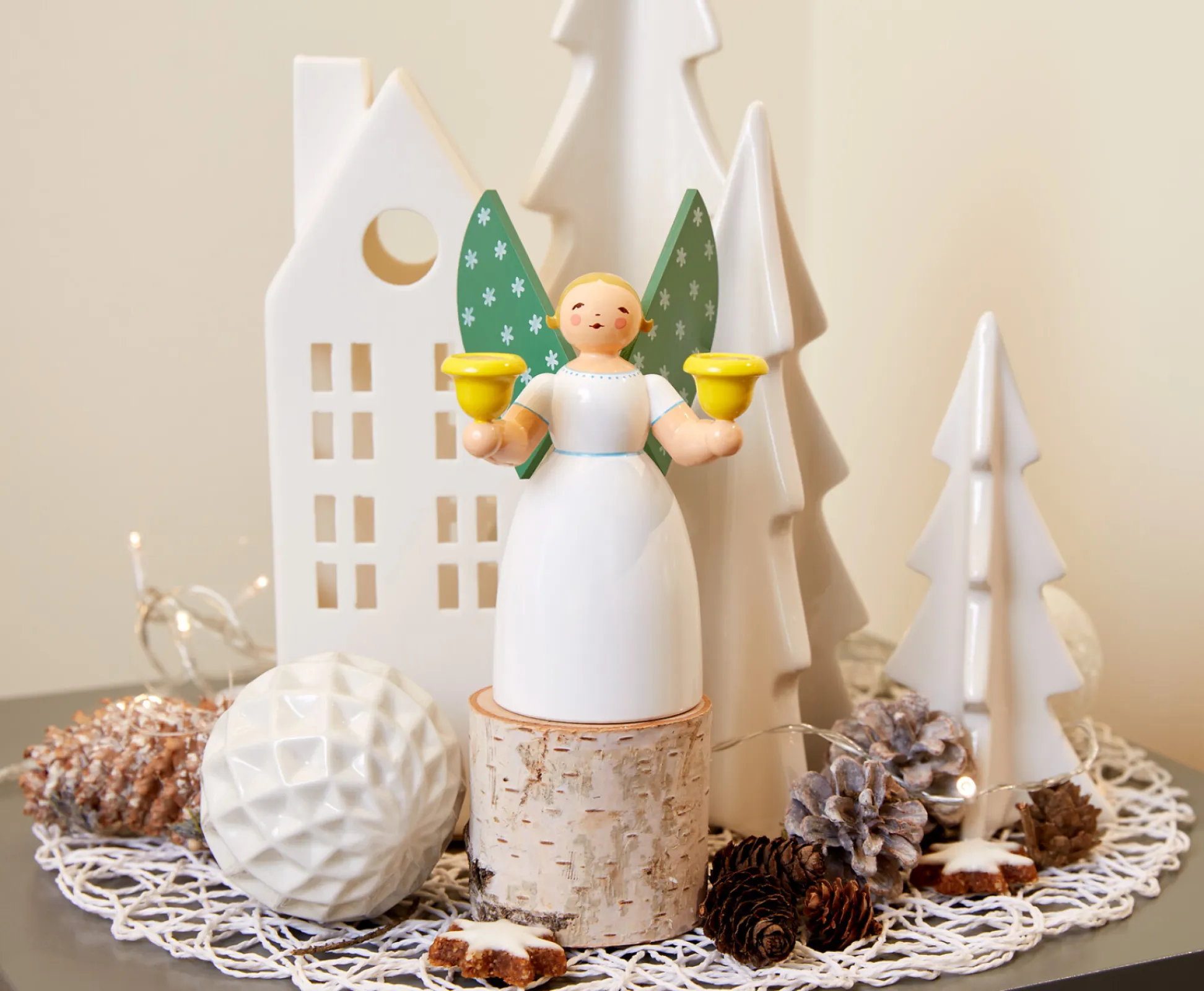 This angel holding candles looks very elegant with its long white dress.