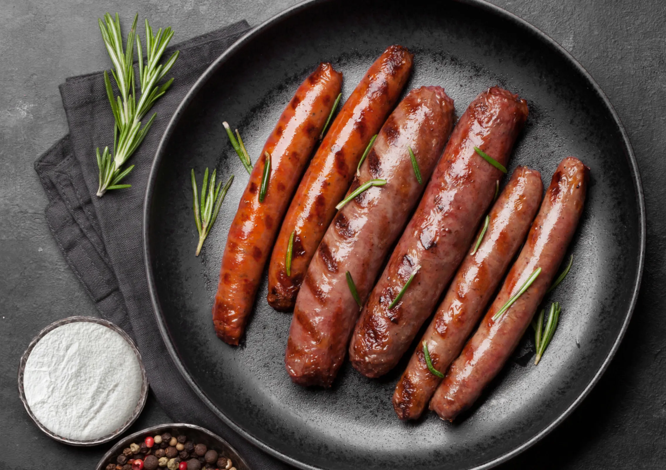 Various brewed and roasted sausages in a pan made with Nubassan A
