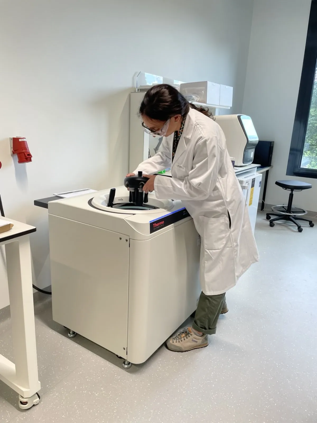 Starting the ultracentrifuge to run a  density gradient during the protein production process.