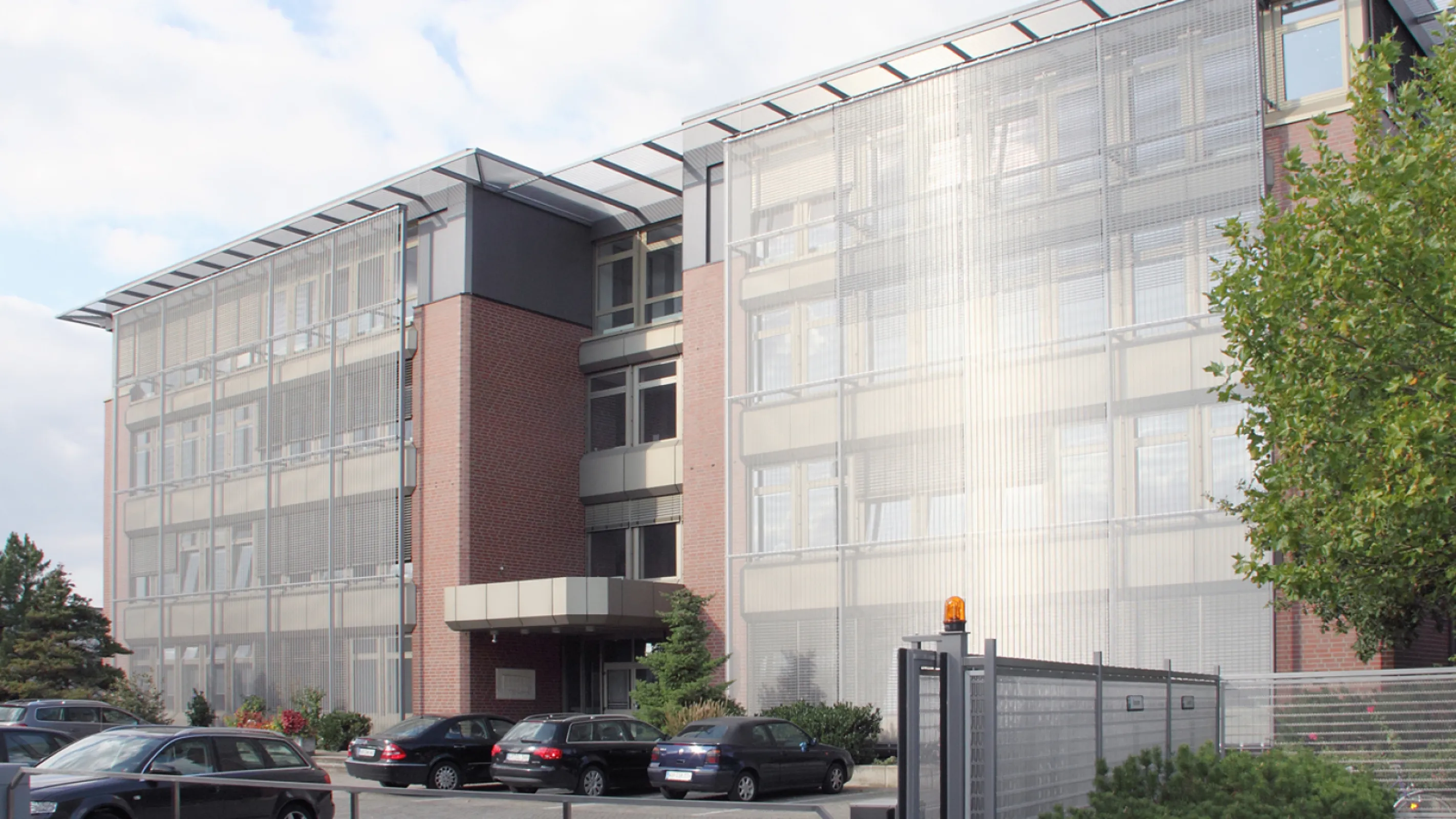 Administration building with facade made of architectural wire mesh.