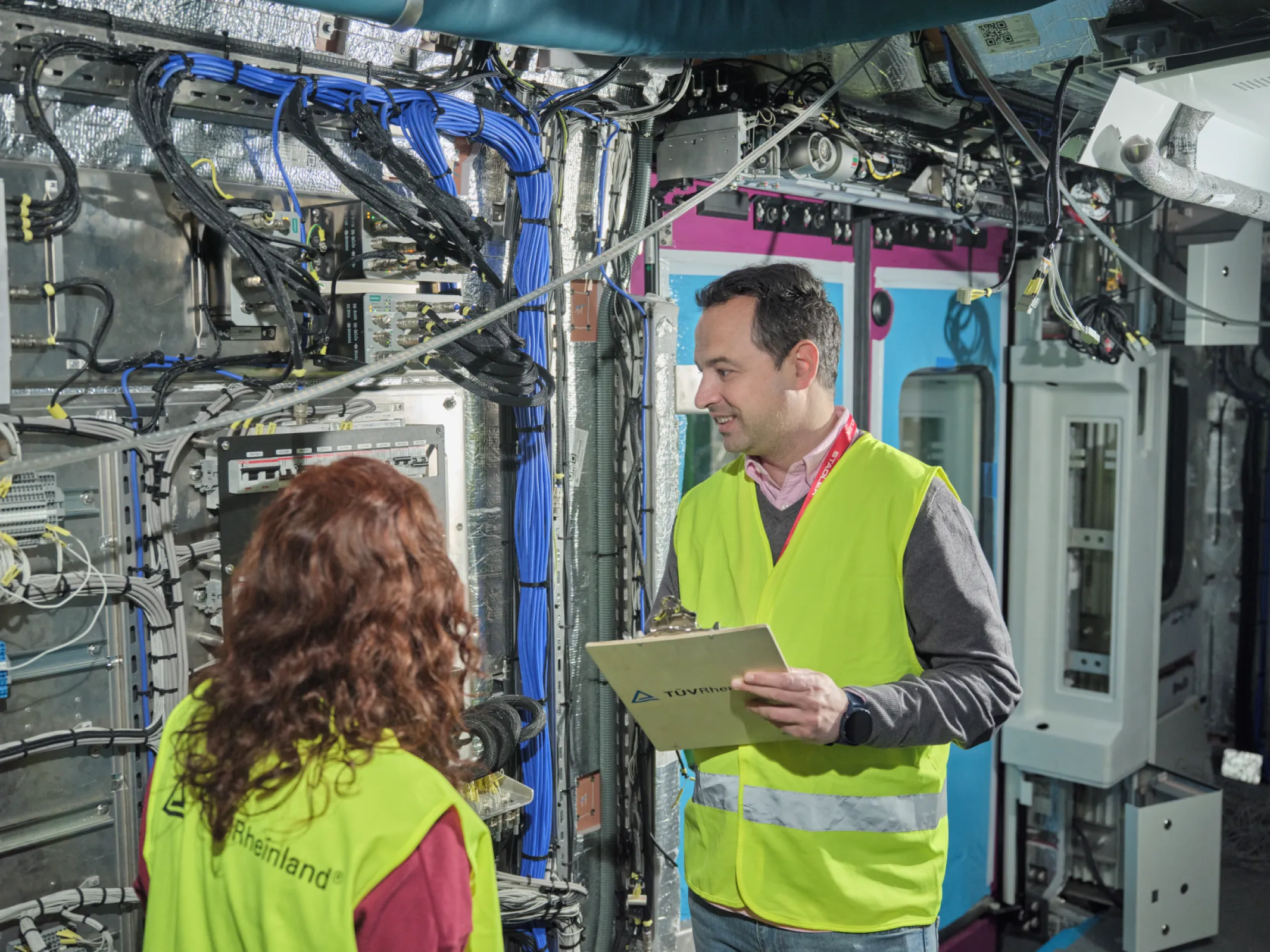 TÜV Rheinland colleagues on-site inspecting a rail system