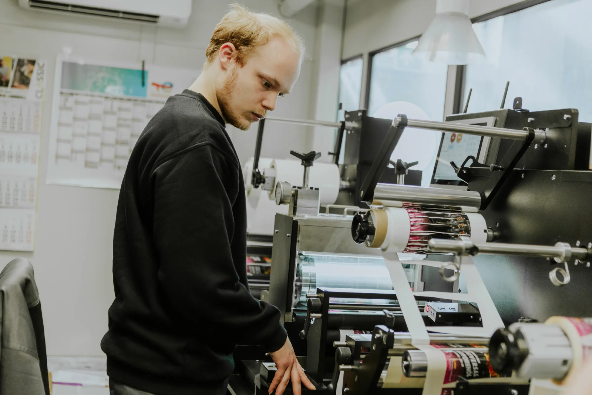 Employee checking the label printing process in the CLASSIC label room.