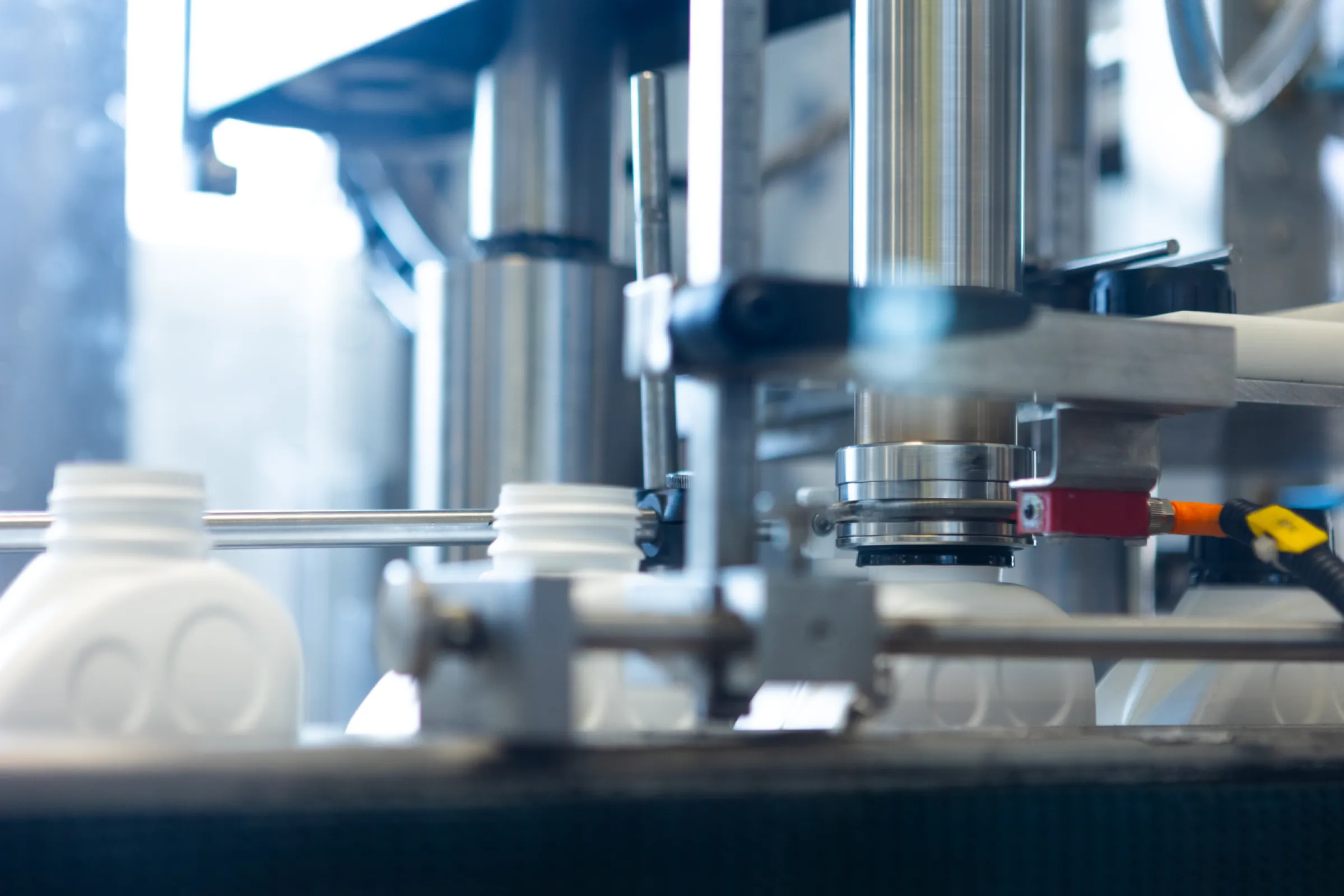 Automated filling and packaging of lubricant products in the production line.
