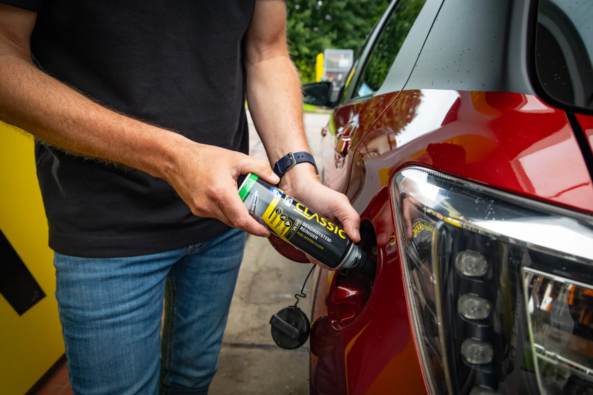 Application of a gasoline system cleaner additive being poured into a vehicle.