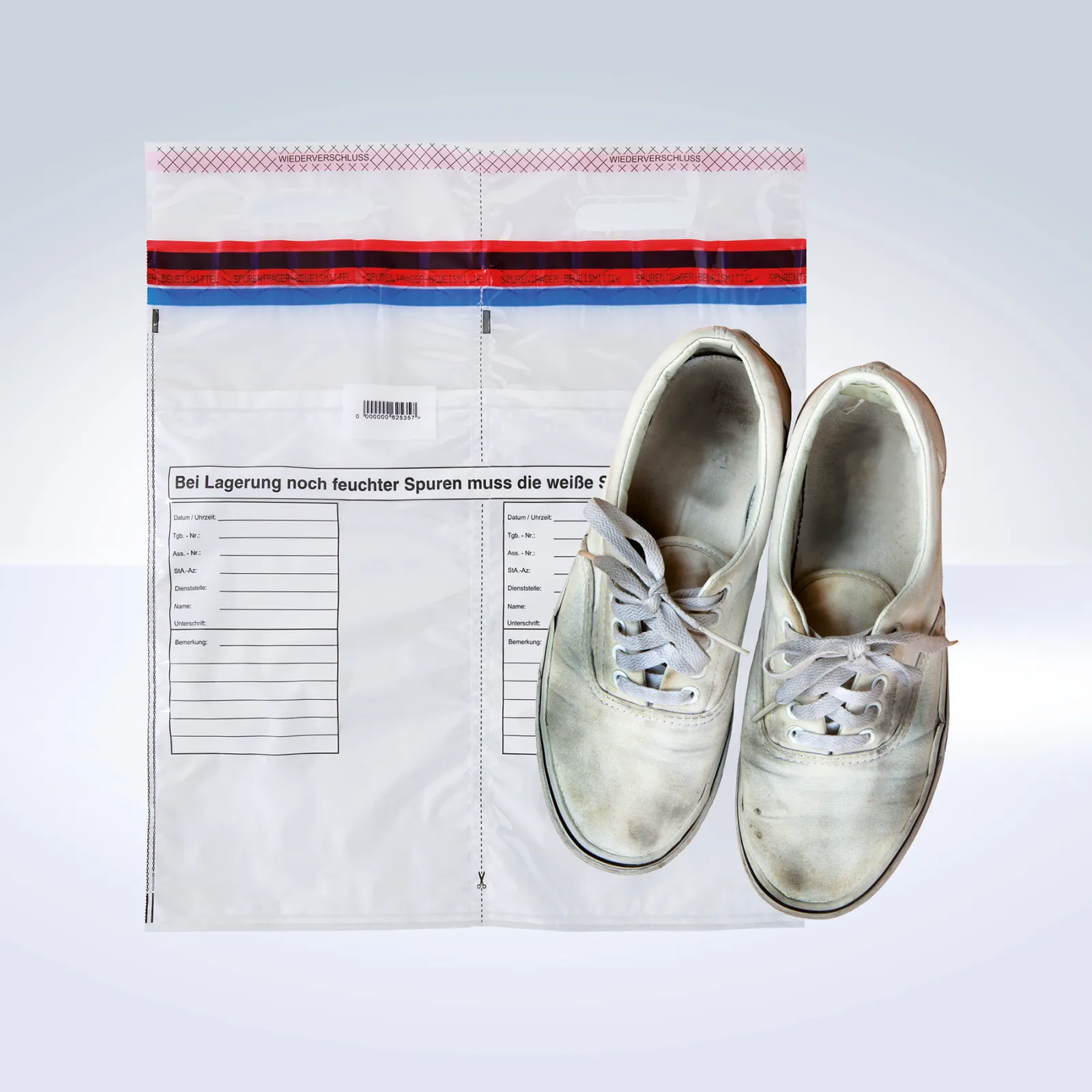 DEBASAFE® forensic shoe bag with two separate transparent chambers and red-blue tamper-evident seal, shown with a pair of white sneakers placed in front of the bag.
