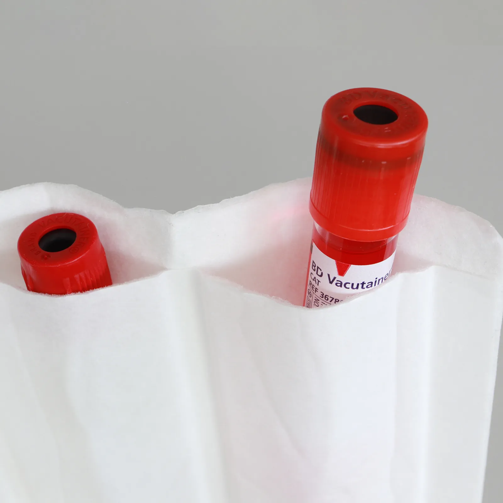 Close-up of the DEBAMED® Absorber with Compartments holding red-topped sample tubes inside individual chambers.