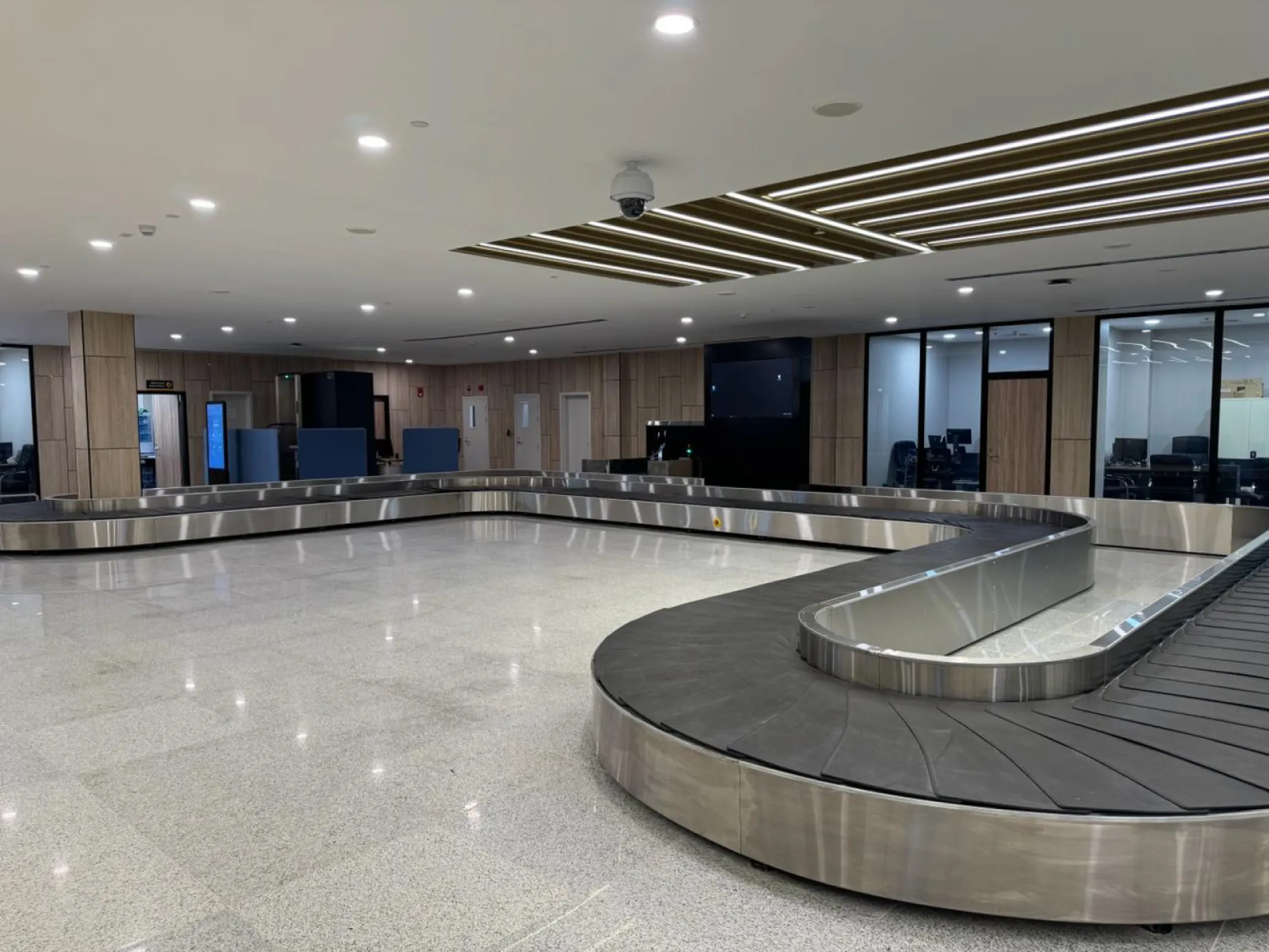 Baggage claim carousel with stainless steel cladding. Also for makeup area with mild steel frame. Length and shape to specification.