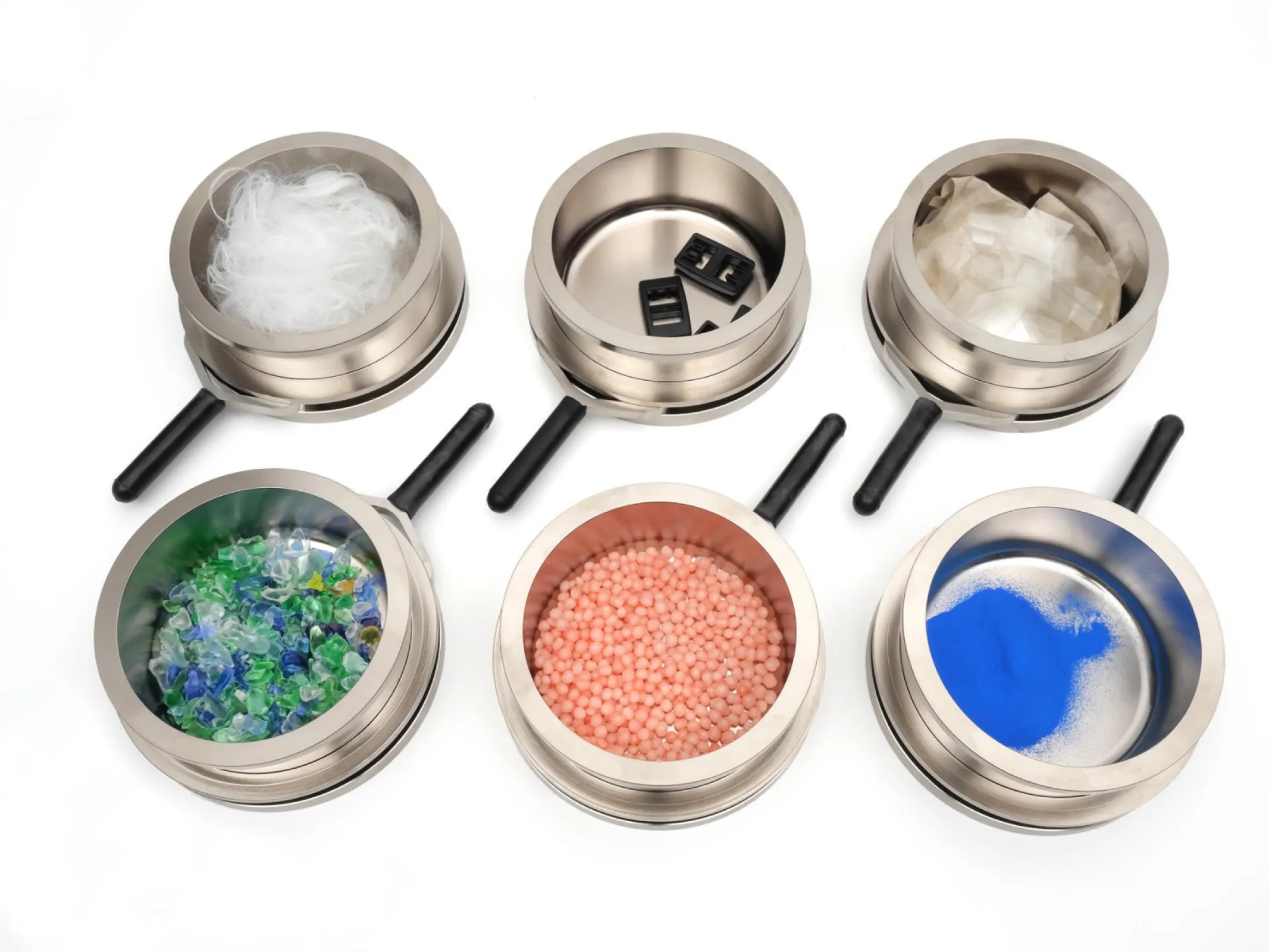 HydroTracer HT3 sample tray loaded with example materials: granules, fibers, molds, regrinds, films, and powders.