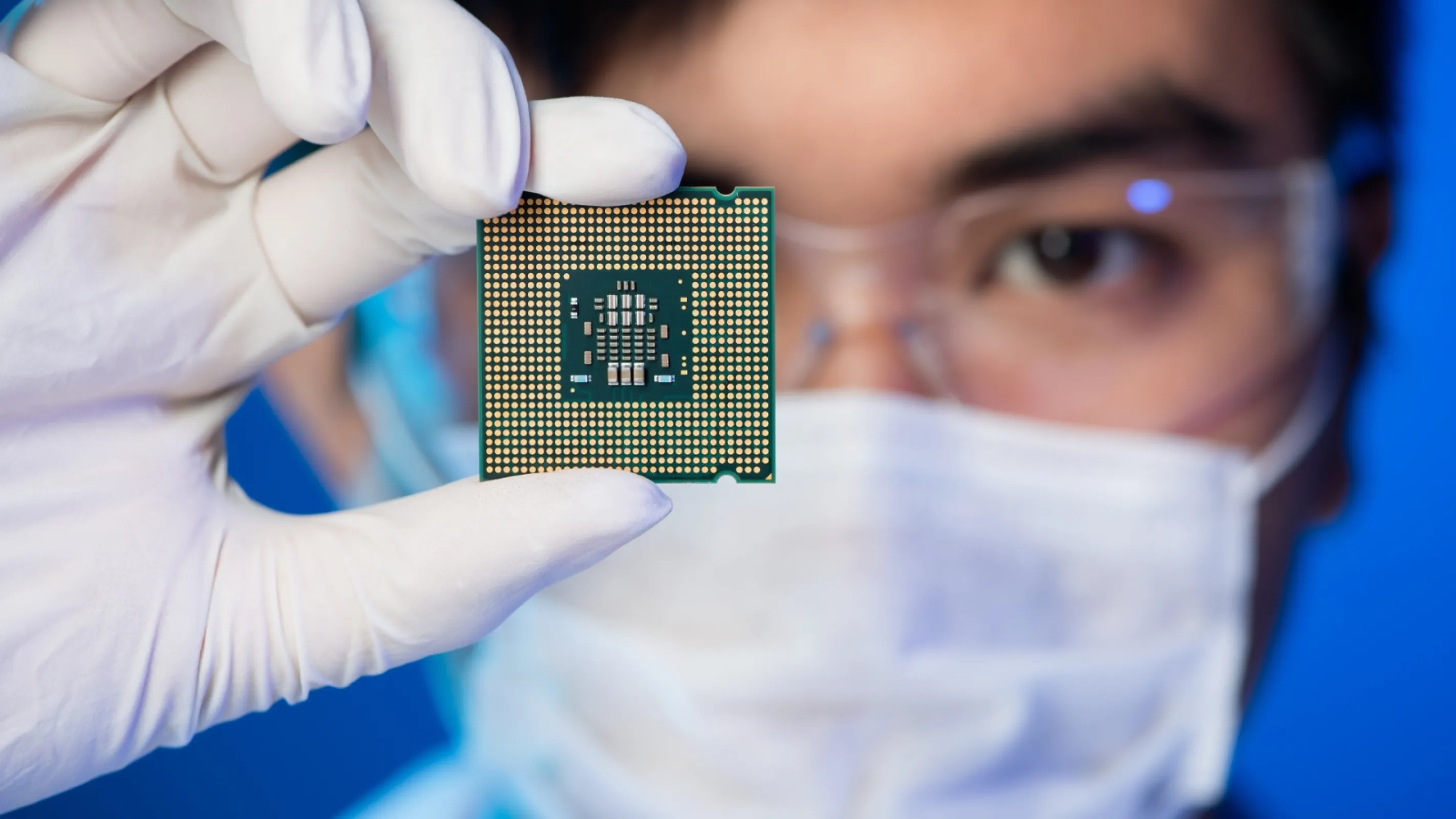 Electronics-engineer-showing-a-microchip-in-the-foreground