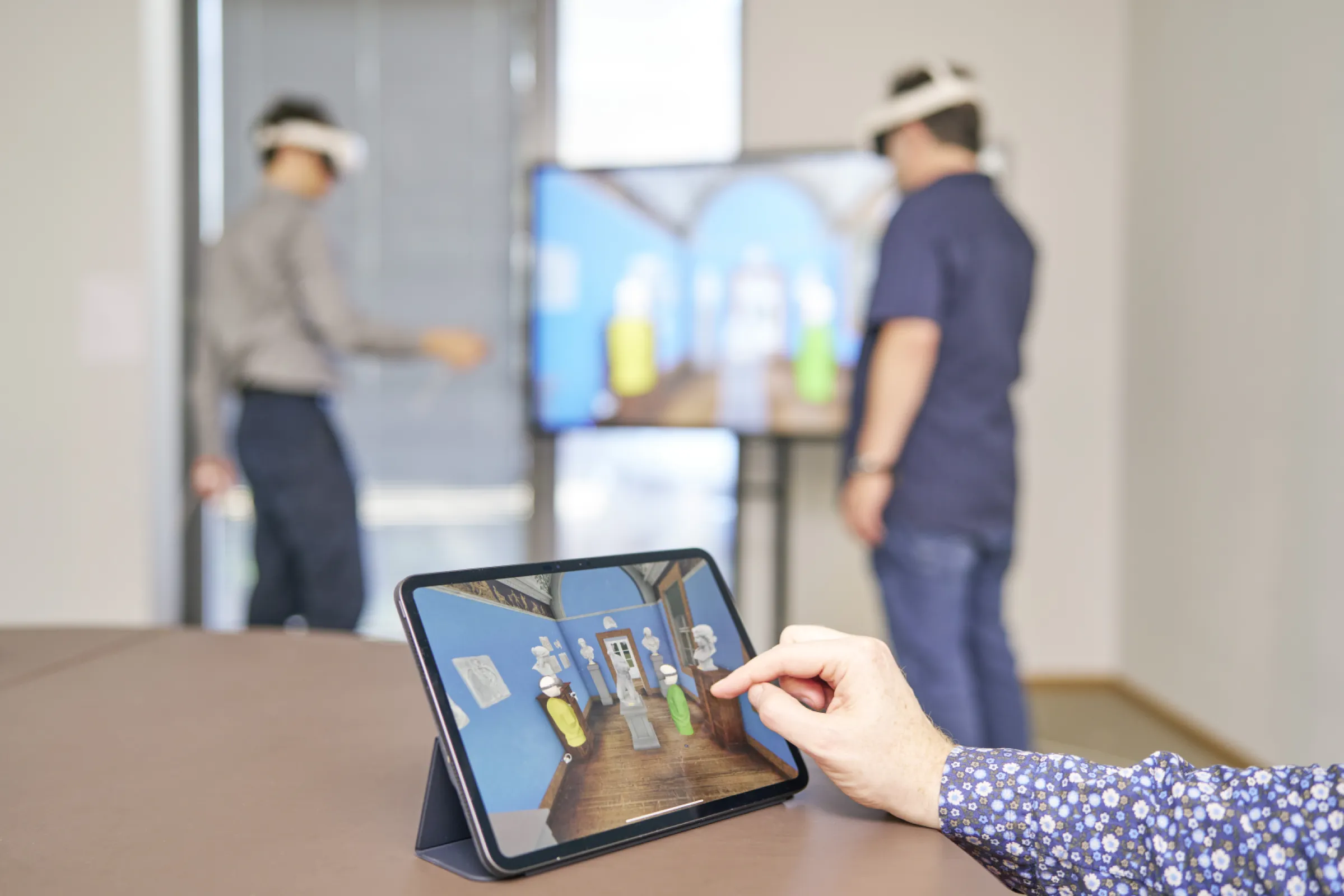 Non-immersed users can be involved via large public screens or interactive tablets in VR or AR mode.