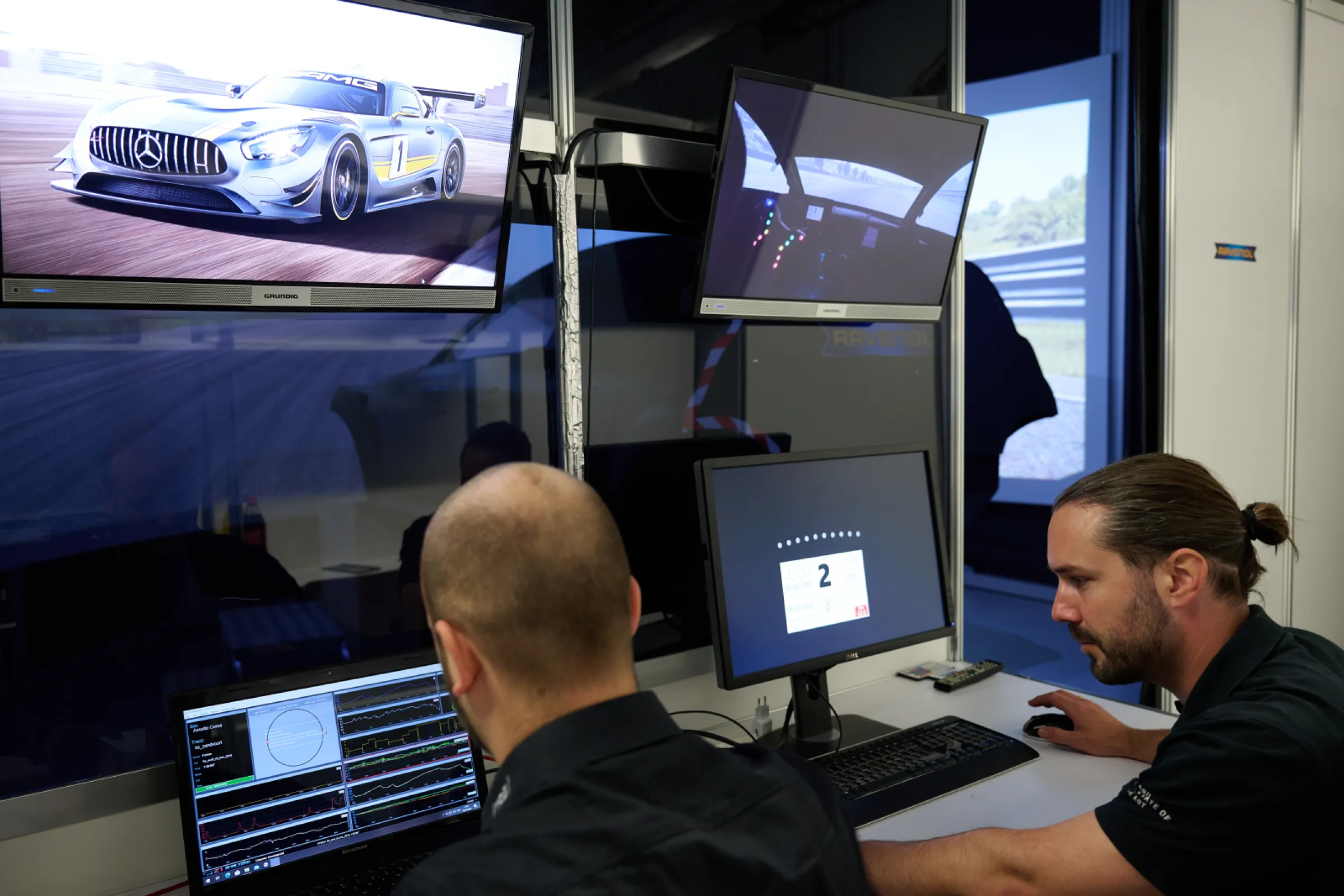 Race engineers analysing performance data