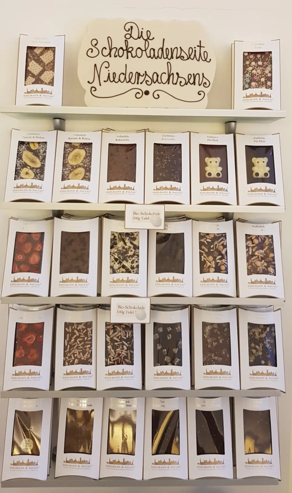 Different types of organic chocolate bars in gift boxes in dark or milk chocolate