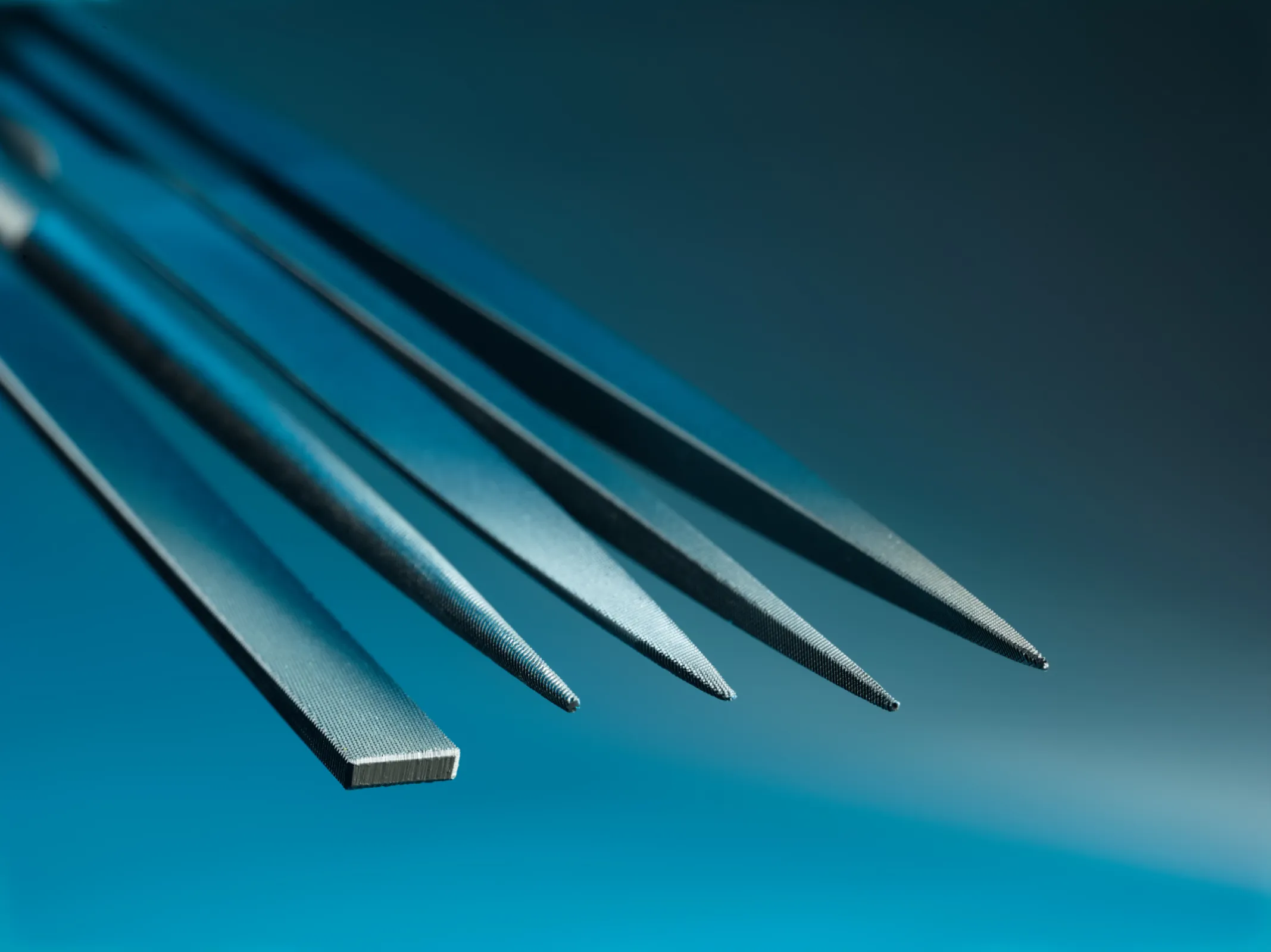 This image showcases a selection of NIQUA files in various profiles—flat, half-round, and round—highlighting their sharp, uniform tooth structure and perfectly tapered geometries for precise shaping and finest finishing. This image showcases a selection of NIQUA files in various profiles—flat, half-round, and round—highlighting their sharp, uniform tooth structure and perfectly tapered geometries for precise shaping and finest finishing.
