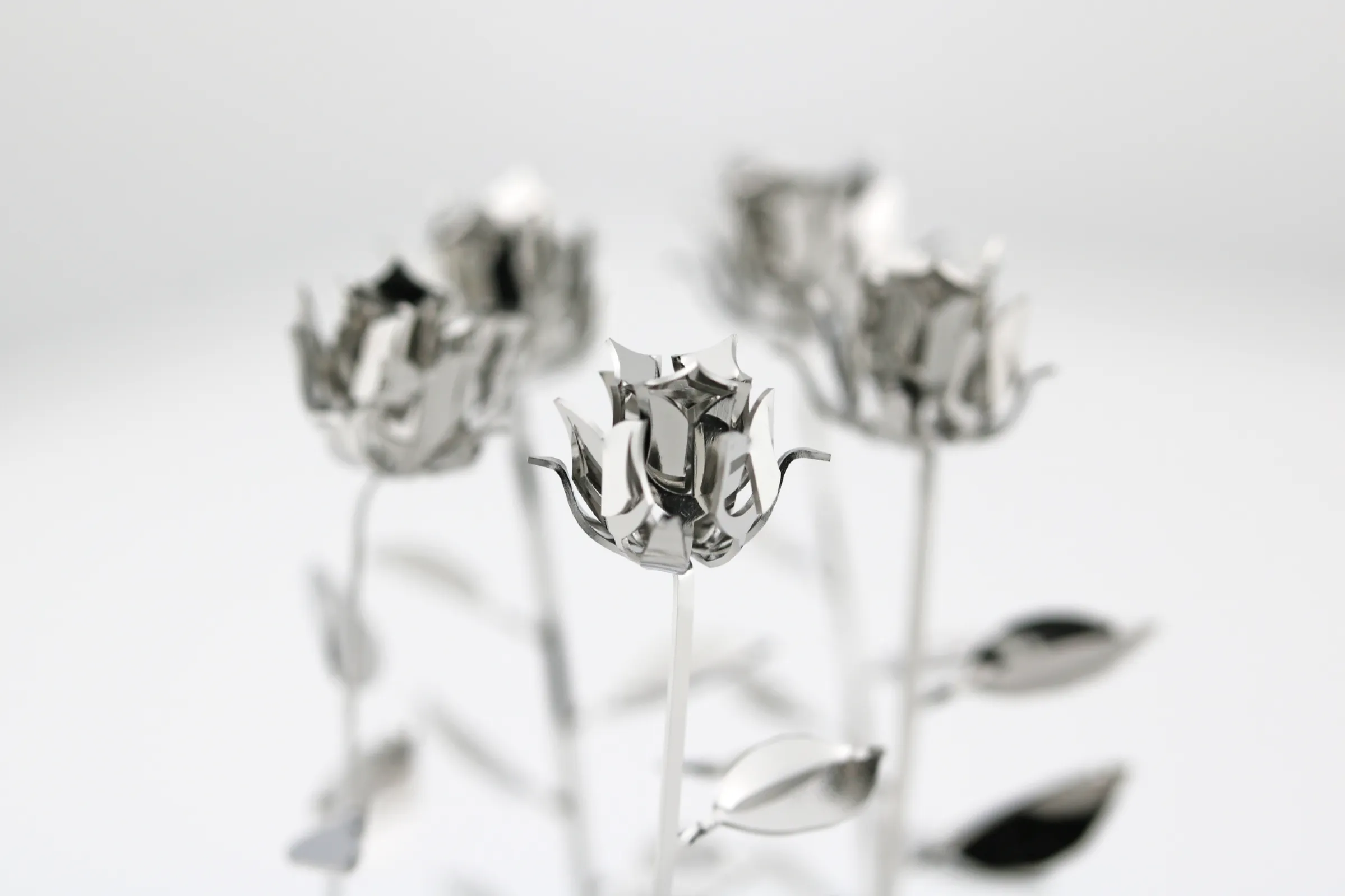 Delicate roses bent out of stainless steel sheets