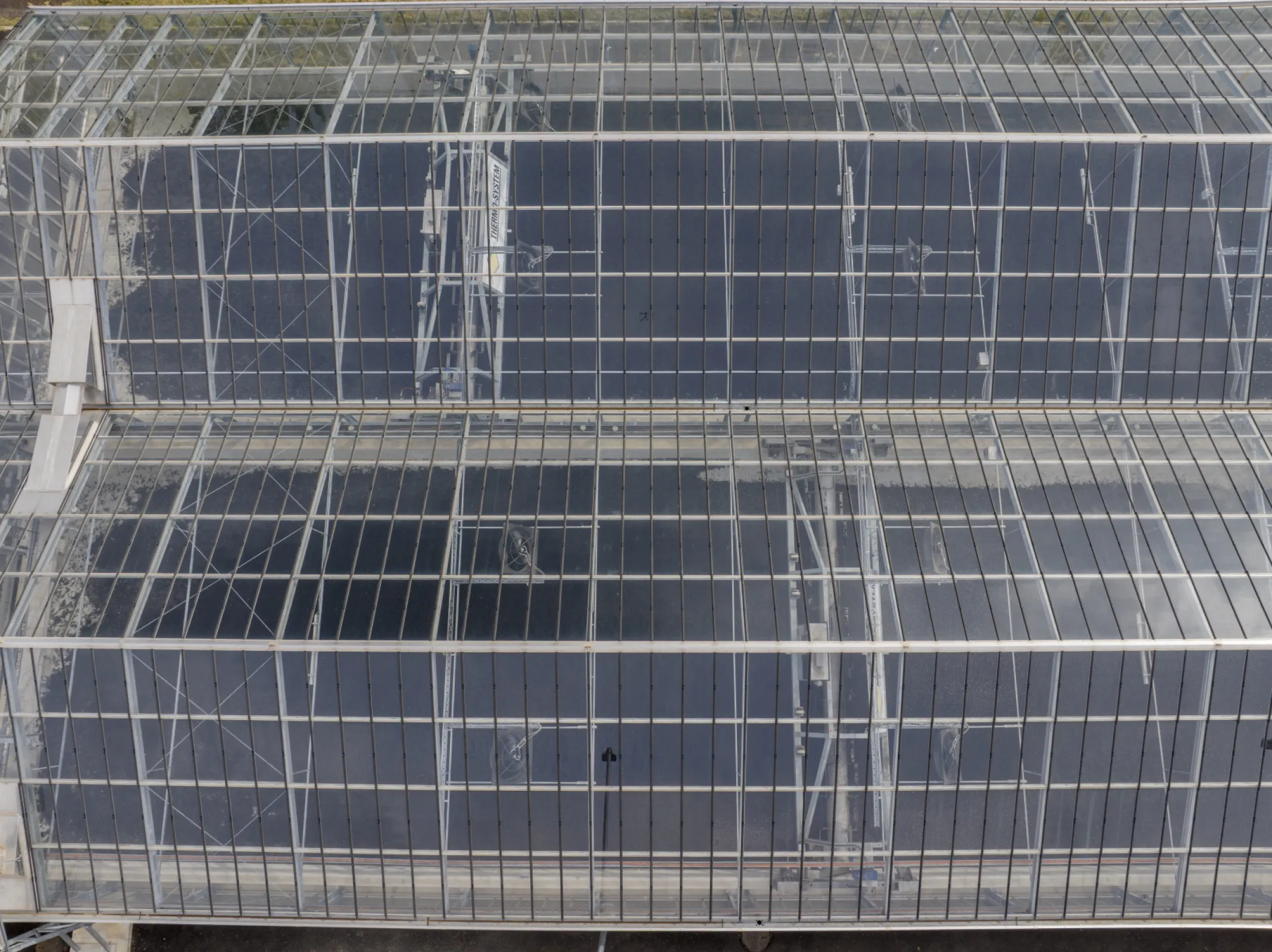 Thermo-System | SludgeTiller - Essentially consists of a stable mobile frame and a rotating drum with turning tools that covers the entire width of the drying bed, which enables to distribute, mix and turn the drying material extremely efficiently.