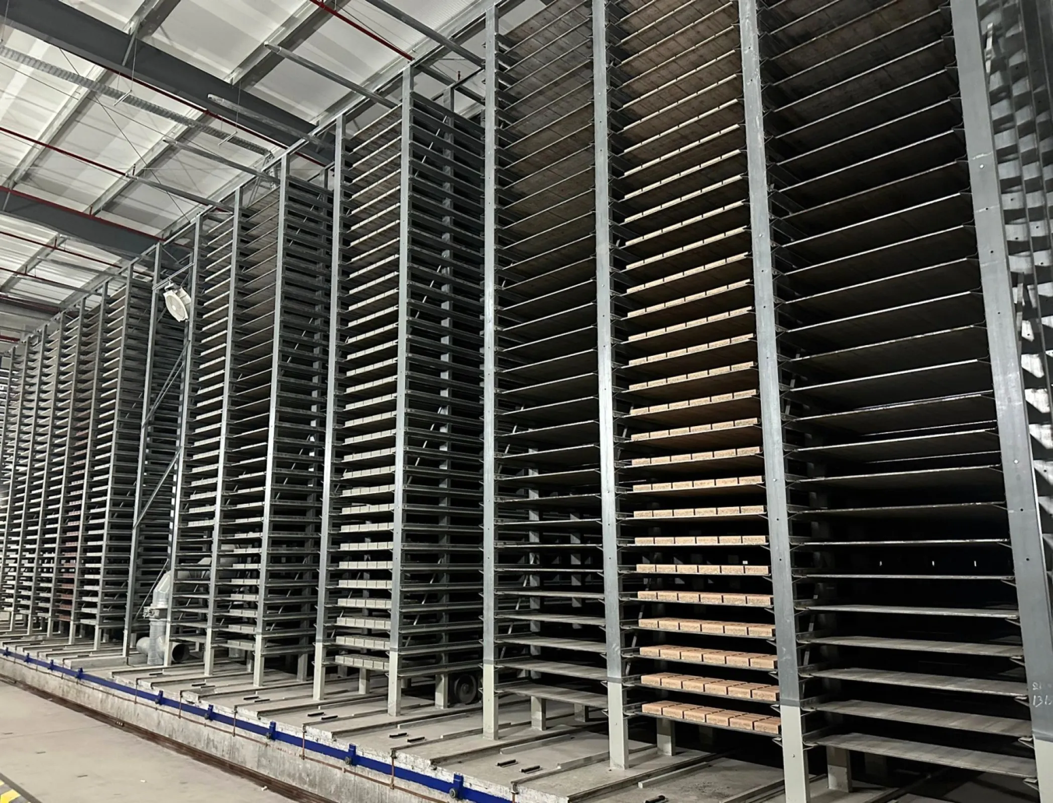 Front view of an indoor curing rack with curing system