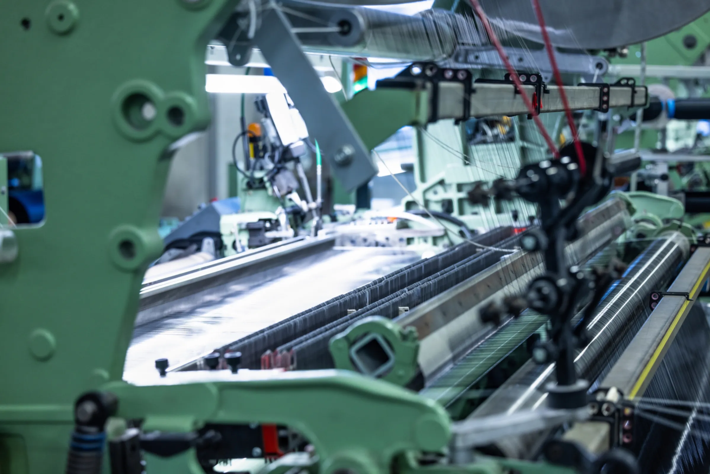 Industrial weaving machine producing technical fabric at ETTLIN’s manufacturing facility