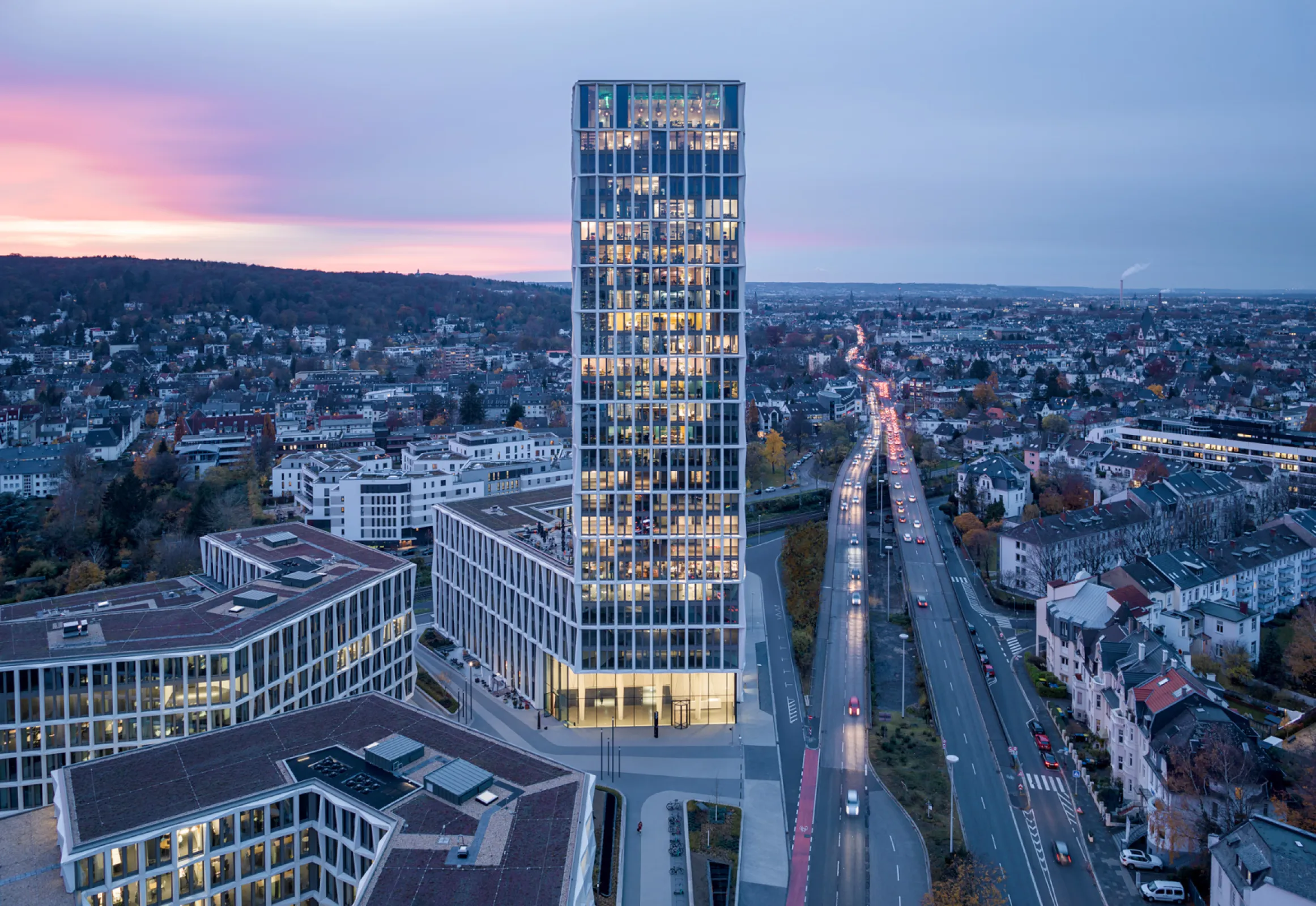 Three office buildings surround a public square. © HG Esch Three office buildings surround a public square. © HG Esch
