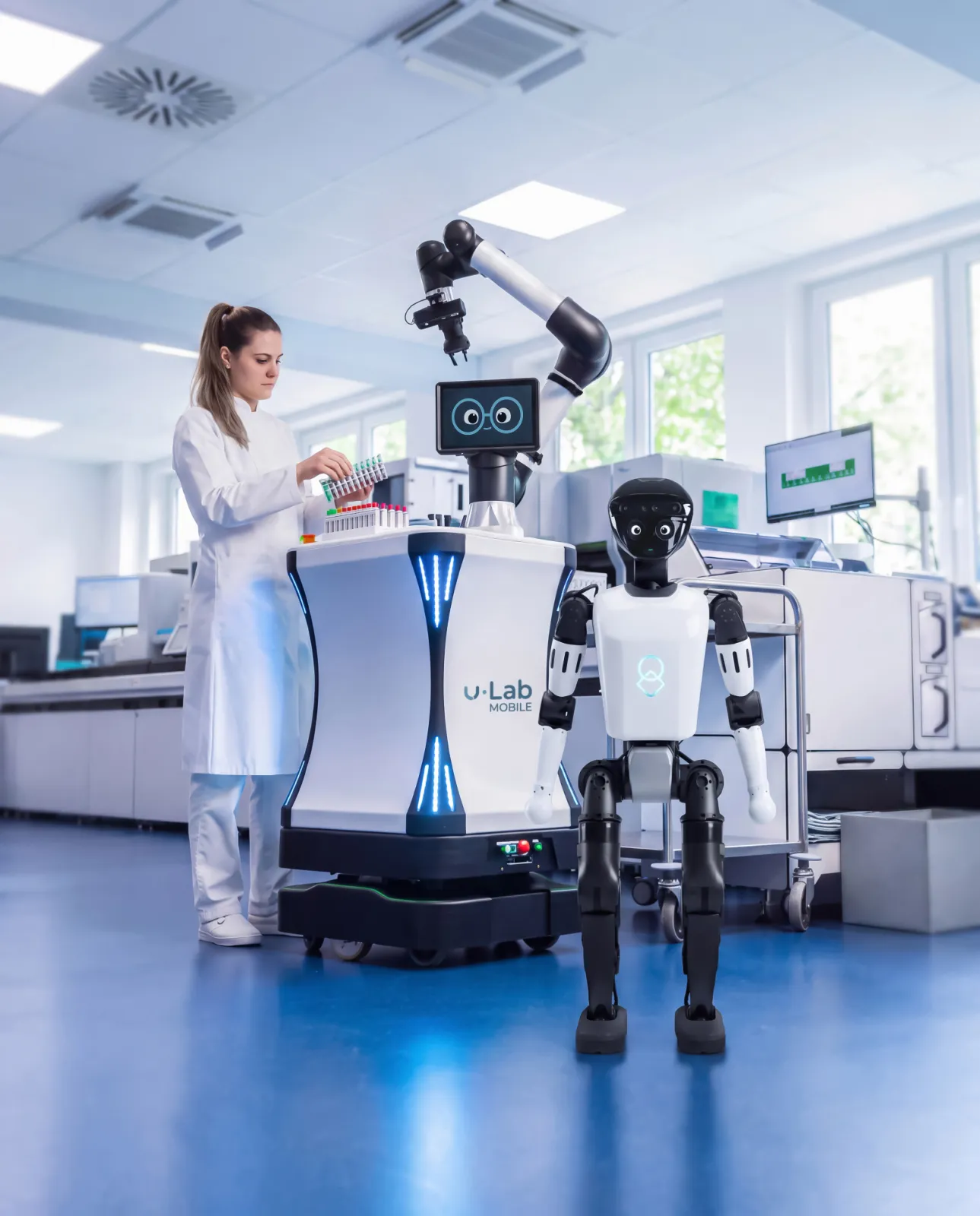 uLab Mobile and the humanoid uMe working alongside a medical technologist in a clinical laboratory.