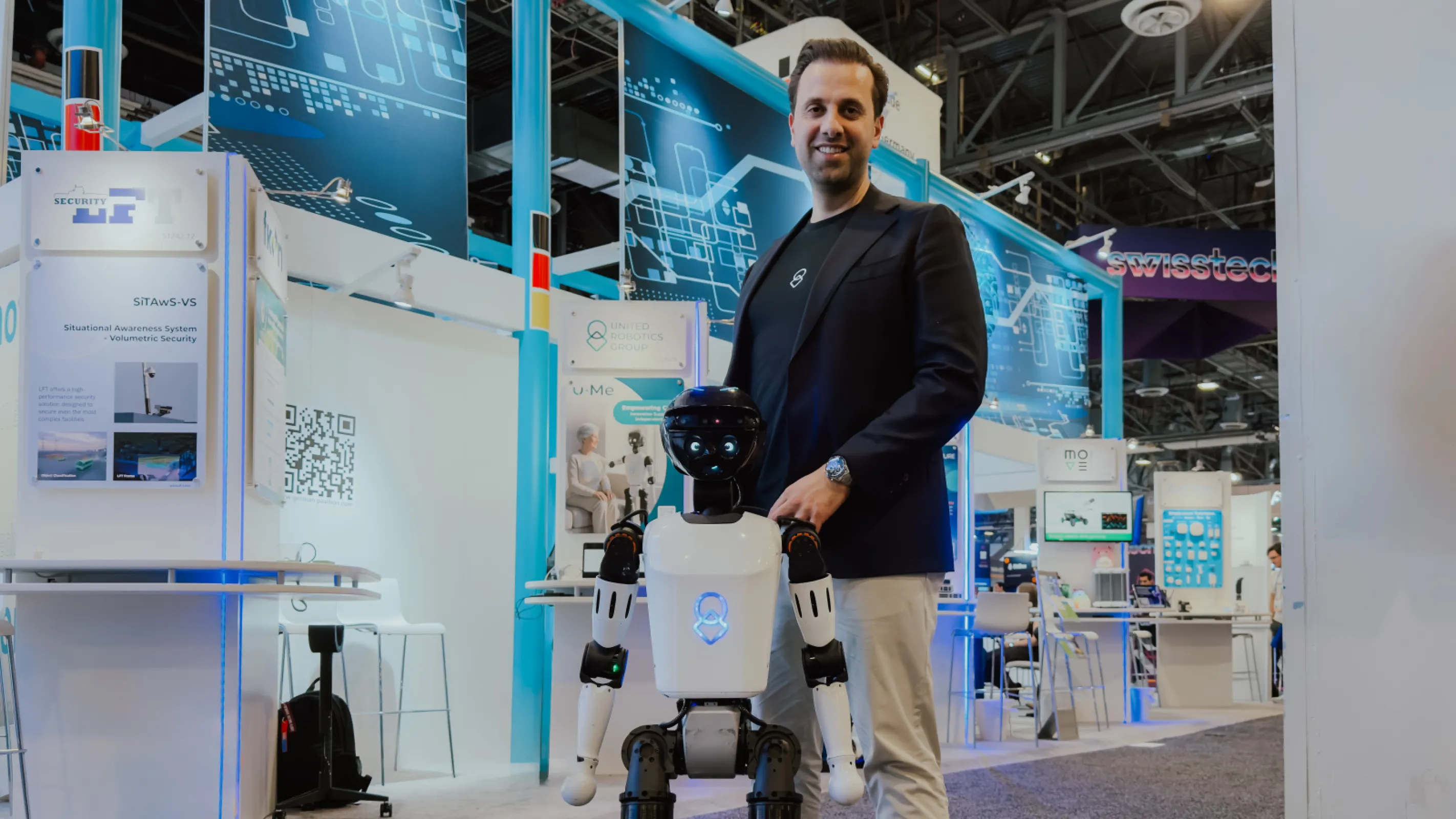 The United Robotics Group stand at CES, with the humanoid robot uMe welcoming visitors.