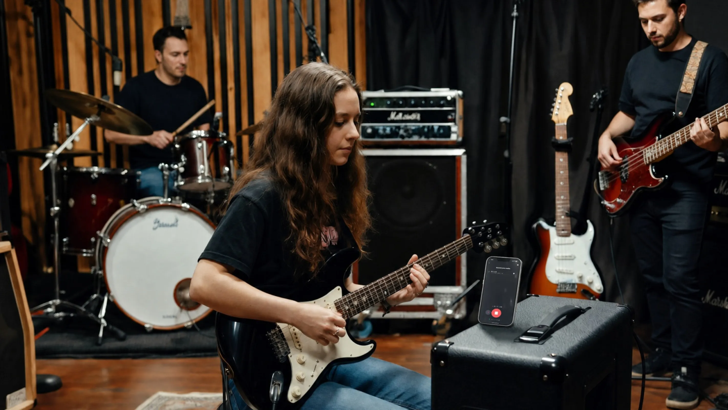 Recording a guitar part into the Klangio mobile app during a band session.